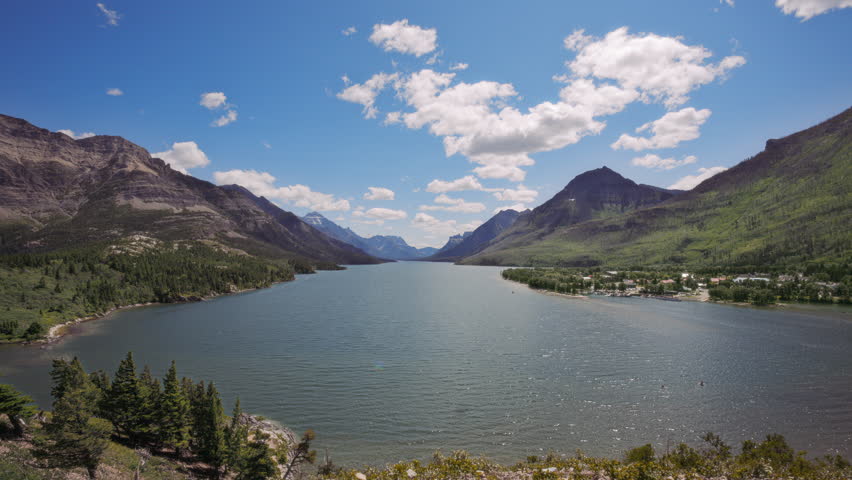Upper Waterton Lake between the mountain peaks on a sunny summer day in Waterton Lakes National Park, Canada. Timelapse.