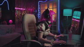 Caucasian girl wearing maid costume with pink wig and cat ears playing video game during live streaming