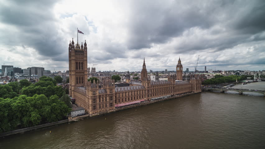 Establishing Aerial View Shot of London UK, United Kingdom, Westminster, Elizabeth Tower, British Parliament, Big Ben, cloudy day, circling right Royalty-Free Stock Footage #1105843009