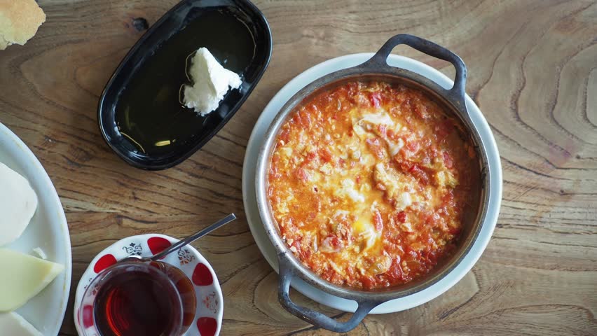 Turkish breakfast with Menemen omelet in a frying pan. .