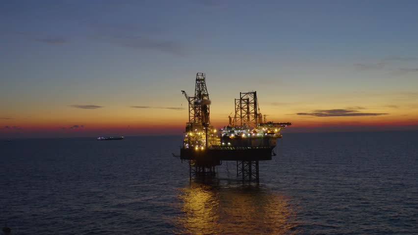 Aerial view of offshore jack up drilling rig during early night time - oil and gas industry
 Royalty-Free Stock Footage #1105849707