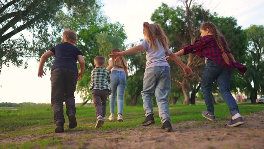 children in the park. boys and girls run through the green park laughing. spending time with friends. happy family kids dream concept lifestyle Royalty-Free Stock Footage #1105850607