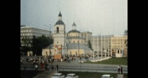 City life in city center. People crowds move, walking along street in summer. Wide footage. Cityscape panorama. Historic busy Moscow town in old retro 1980s archive video. Archival vintage color film