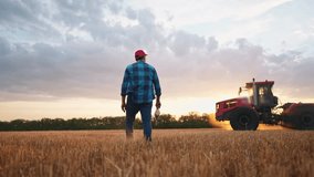 agriculture. farmer walk works in field next to a tractor that plows the land. business agriculture concept. farmer with tablet works in a field next to a tractor at sunset mowed farm wheat plows - Powered by Shutterstock - Get 15% off with code: PIKWIZARD15