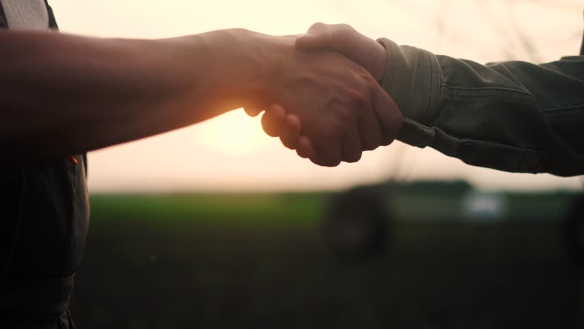 farmers handshake business contract. two farmers at sunset with corn irrigation plant in the background shaking hands. agriculture irrigation business concept. farmers handshake lifestyle Royalty-Free Stock Footage #1105853317