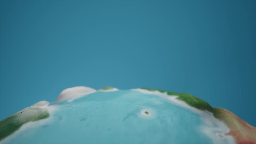 cartoon animation with spinning earth globe with blue backgorund liek sky. Tropical exotic look with blurr