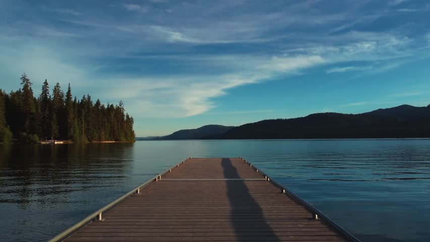 Wooden Dock On Pristine Waters Of Priest Lake In Bonner County, Idaho. wide drone shot