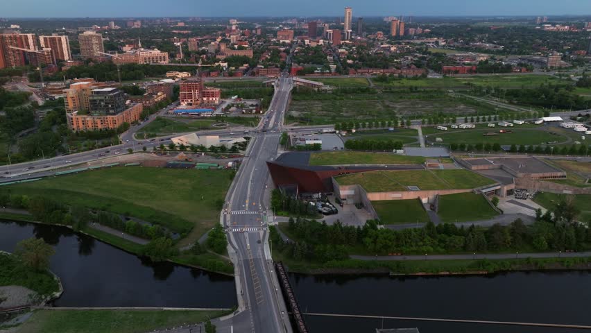 Slow tilt up from the Canadian War Museum revealing the empty lot of the Lebreton Flats in the Background. Ottawa, Aerial. Royalty-Free Stock Footage #1105873291
