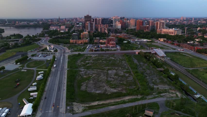 Ottawa's downtown is seen in the background as drone circles over empty lot of the Lebreton Flats. Royalty-Free Stock Footage #1105873293