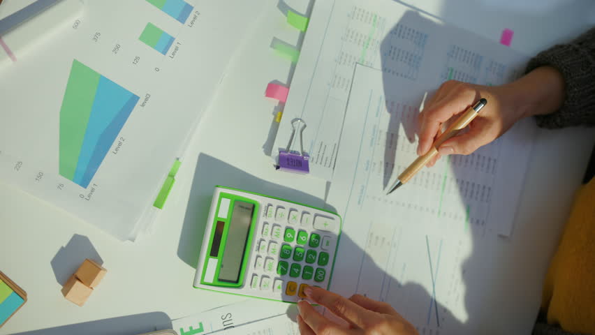 accountant woman with calculator and documents working in office. Royalty-Free Stock Footage #1105874259