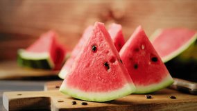 Watermelon stock video 4k. Slices of fresh watermelon on the rustic wooden table