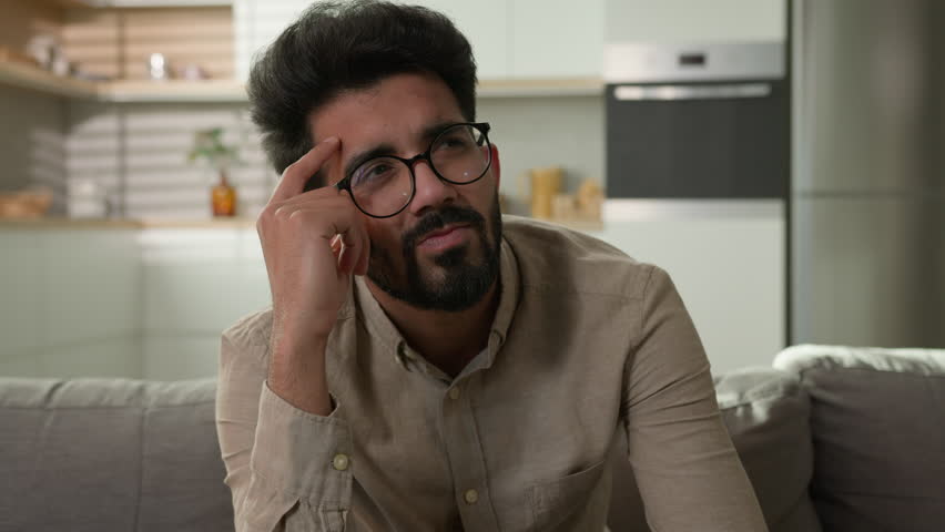Thoughtful Indian man confused puzzled Arabian muslim guy thinking idea in home kitchen pensive think deep in thoughts pondering dreaming solving difficult solution creative imagine search inspiration Royalty-Free Stock Footage #1105878349