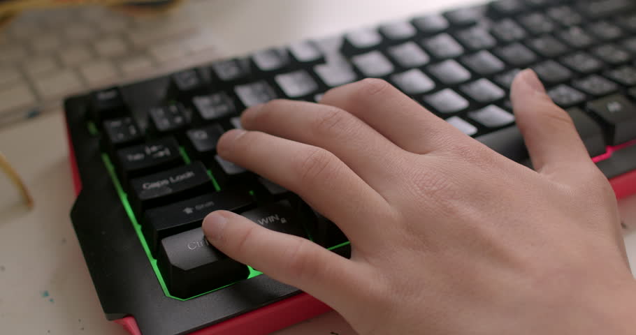 Character control Keyboard buttons press teenager navigate game world, controlling character movement, hand closeup. Intelligent content recommendation aids studying E-learning tools for personalized  Royalty-Free Stock Footage #1105879323