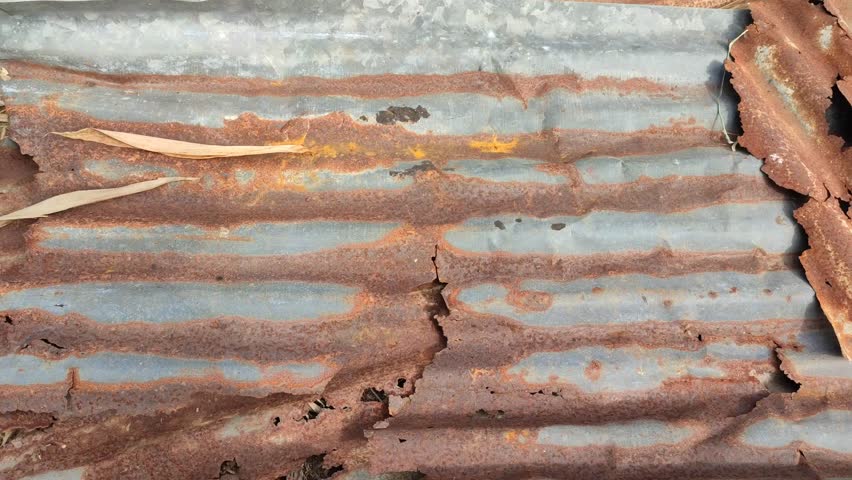 sheets of old, rusty zinc lying on the ground Royalty-Free Stock Footage #1105885727