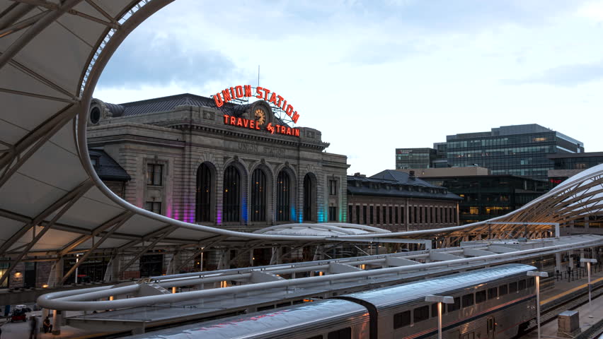 Denver , Colorado , United States - 06 14 2023: Motion timelapse of trains and people at iconic Union Station in downtown Denver