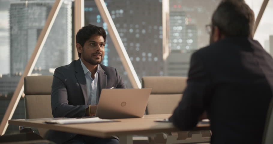 Young Indian Businesspeople Closing a Business Deal at a Meeting Room in Corporate Modern Office. Two Men in Classic Suits Shake Hands and Celebrate Successful Partnership Royalty-Free Stock Footage #1105891443