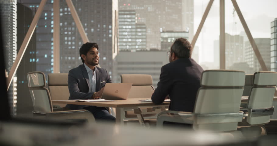 South Asians Business Partners Striking a Successful Deal at a Corporate Modern Meeting Room. Two Young Indian Businessmen Shaking Hands After a Positive Negotiation Process Royalty-Free Stock Footage #1105891461