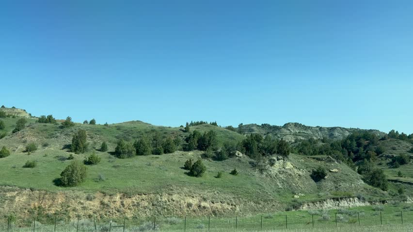 Driving through the badlands hills and mountains in Theodore Roosevelt National Park in North Dakota.