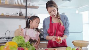 Young asian mother cutting apples to little daughter eating. Mother teaching little daughter cutting apples and enjoy eating. Eating fruit for health care. Happy family, Healthy food - Powered by Shutterstock - Get 15% off with code: PIKWIZARD15