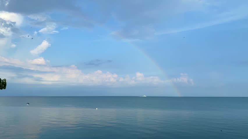 Rainbow after the rain over the sea. High quality 4k footage