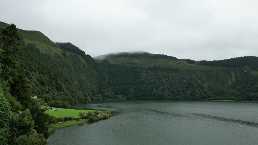 Flying over Lagoa Azul in Sao Miguel island of the Azores on a misty, moody day.
