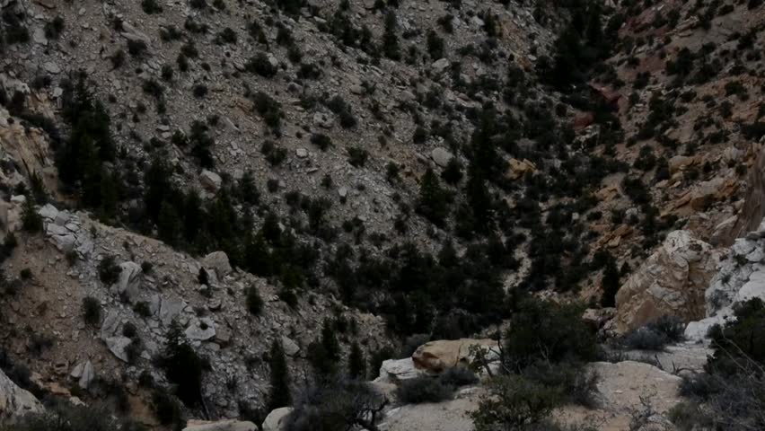 Pan up from deep desert canyon into thunderstorm sky. Filmed at the Ghost Rock view area in the San Rafael Swell of Utah.
