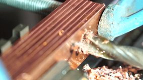 metalworking industry: close up hole drilling in copper bars for electrical connection on lathe boring machine with lubricant - Powered by Shutterstock - Get 15% off with code: PIKWIZARD15