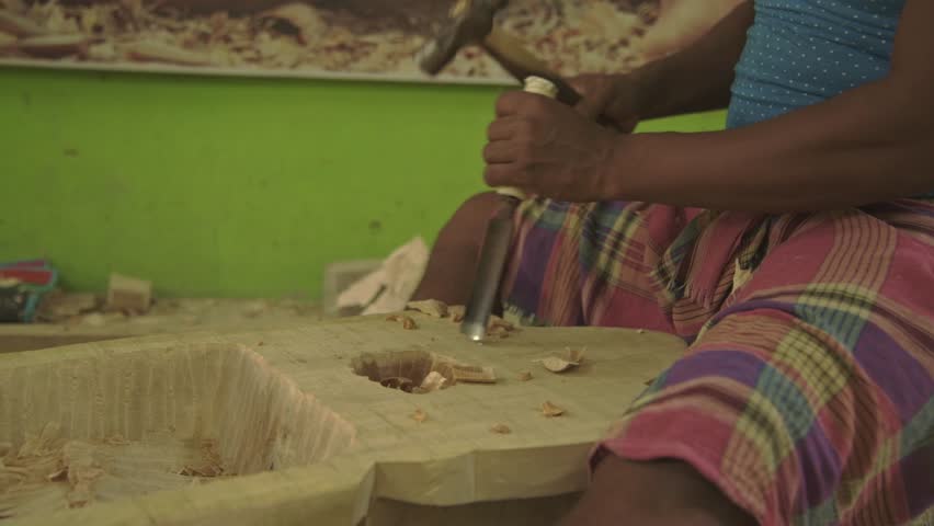 carpenter is curving wood to make Gomira mask or Mukha