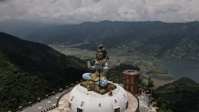 Aerial view of the statue of Lord Shiva in Nepal. Drone flight with a view of the Mahadev Monument in Pokhara. Cinematic 4k footage.