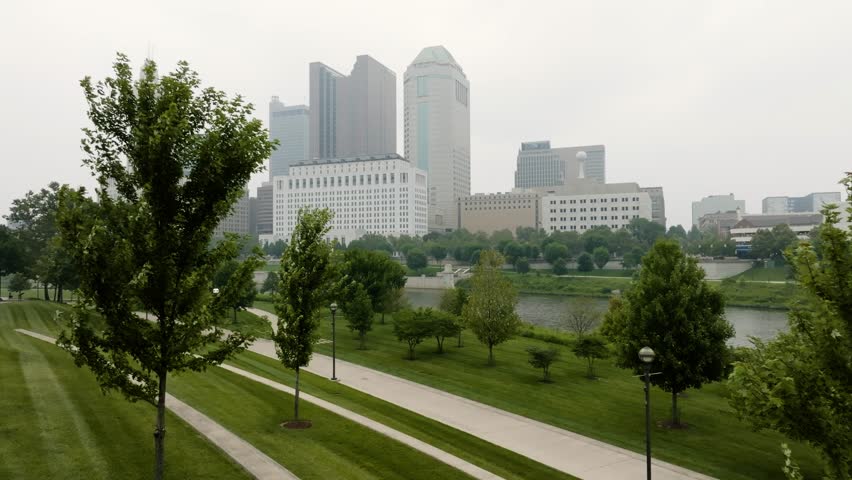 Aerial view of Columbus Ohio skyline from Genoa Park through trees on a foggy smoky day