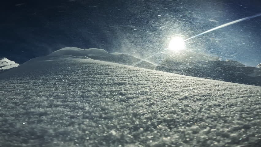 Drifts with soft snow brought by Wind Transport for skiing, extreme winter sports. Ski resort with fresh snow covered in windy weather as Wind Transport maps out new slopes for skiing and snowboarding | Shutterstock HD Video #1105910621