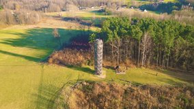 Wooden lookout tower in Hermanice on sunny spring day, Czech Republic. Aerial 4K footage from drone flight