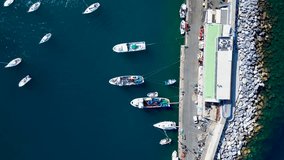 Aerial view of the yacht club. Aerial top-down view of docked sailboats. Top down view of yachts. Top down view of fishing boats.