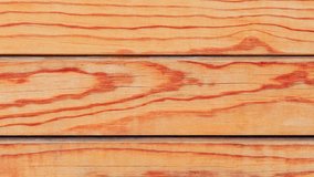 Background, wooden surface made of polished boards with texture, rotating, turning, close-up, looped video

