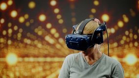The woman wearing VR headset dancing in virtual reality. Led screen with blur background in glow lights.The beautiful woman in modern virtual reality dance game.Concept high technology digital device