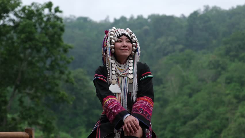 Slow motion of a young woman in Akha traditional dress looking at a beautiful nature