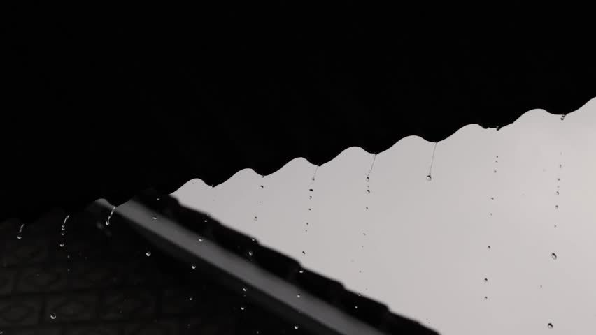 Raindrops dripping from the roof of the house, gurgling to a beautiful tune. Quiet and dim atmosphere. Royalty-Free Stock Footage #1105923335