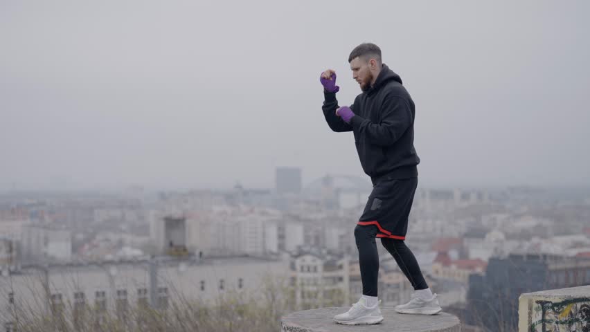 Healthy lifestyle - male boxer exercising in the city | Shutterstock HD Video #1105924087