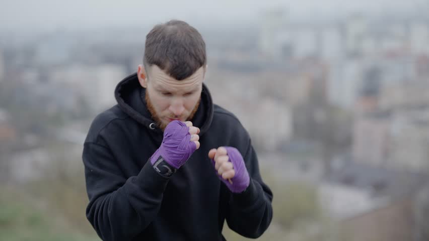 Healthy lifestyle - male boxer exercising in the city | Shutterstock HD Video #1105924243