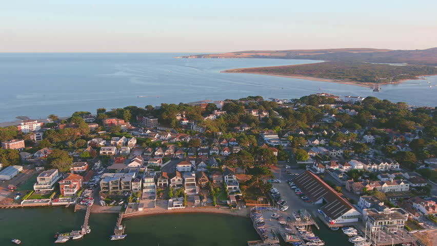 Poole, UK: Aerial view of city in England, seaside resort with famous Beaches by Atlantic Ocean, Sandbanks neighbourhood in summer at sunset - landscape panorama of United Kingdom from above