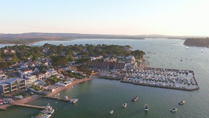 Poole, UK: Aerial view of city in England, seaside resort with famous Beaches by Atlantic Ocean, Sandbanks neighbourhood in summer at sunset - landscape panorama of United Kingdom from above
