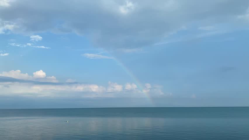 Rainbow after the rain over the sea. High quality 4k footage
