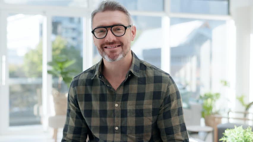 Face, happy man and senior designer in office, startup company or workplace. Portrait, glasses and smile of creative professional entrepreneur, boss and manager from Australia with career in business