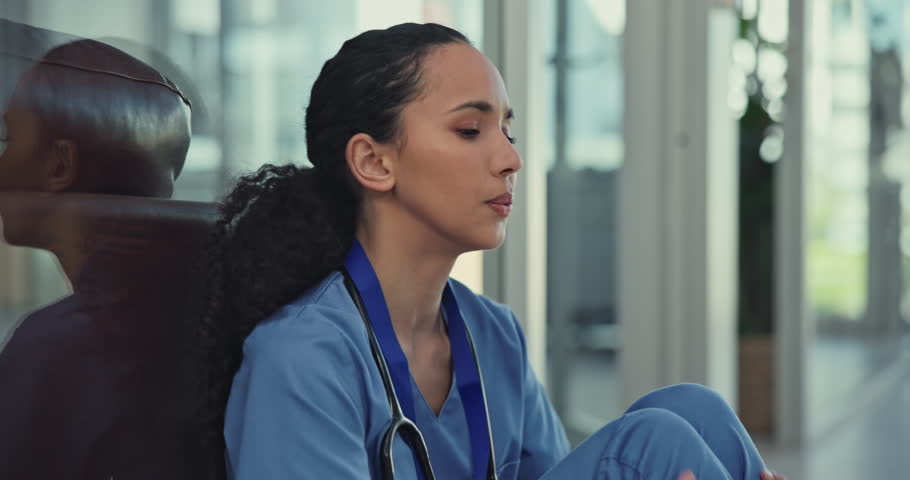 Medical nurse, stress and depression in a hospital corridor for mistake, anxiety or loss and bad news. Female healthcare worker sad, burnout or tired and frustrated with crisis or problem on floor Royalty-Free Stock Footage #1105934419