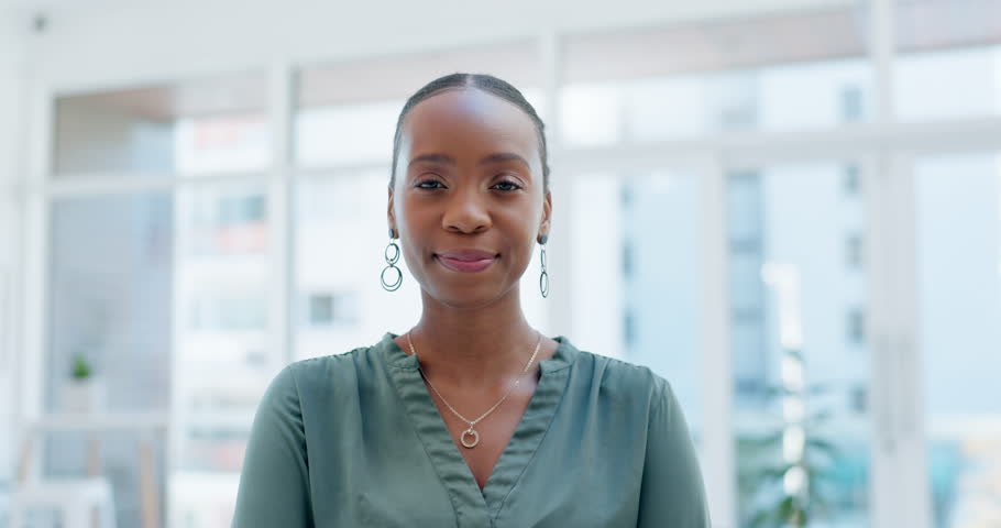Face, funny or comedy with a business black woman laughing at a joke in an office for corporate work. Portrait, smile and comic with a happy young female employee standing in a professional workplace