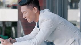 Asian man, texting and phone in office with smile for meme, online date or funny video on social media. Happy Japanese businessman, smartphone and scroll on web app for contact, communication or chat
