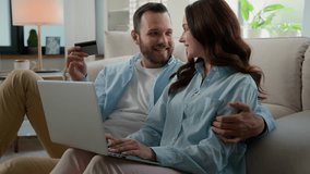 Caucasian happy family couple man woman husband wife with laptop and credit bank card shopping online computer internet payment transaction order food delivery booking tickets at home buying purchase - Powered by Shutterstock - Get 15% off with code: PIKWIZARD15