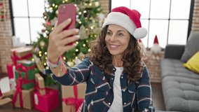 Middle age hispanic woman having video call celebrating christmas at home
