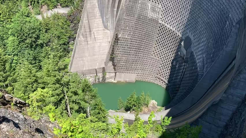 Tilt up view to show the scale of the massive Ross Dam at Ross Lake which is part of the hydroelectric power system that supplies Seattle - North Cascades National Park, Washington, USA.