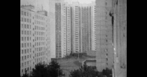 High-rise residential buildings, city view. Urban apartment housing. Exterior architecture. Prefabricated houses complex. Archival vintage black white film. Old retro archive. 1980s Moscow, Russia